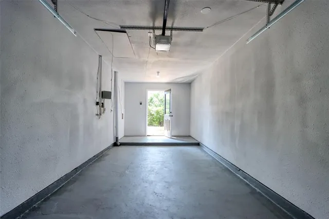 a view of a hallway with wooden floor and a window