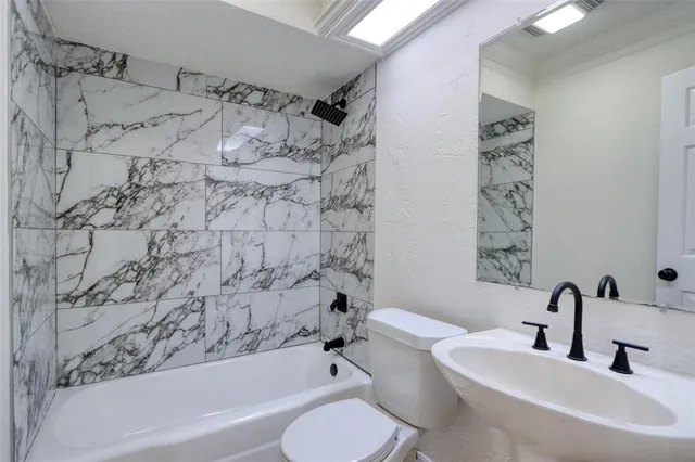 a bathroom with a toilet sink and bathtub