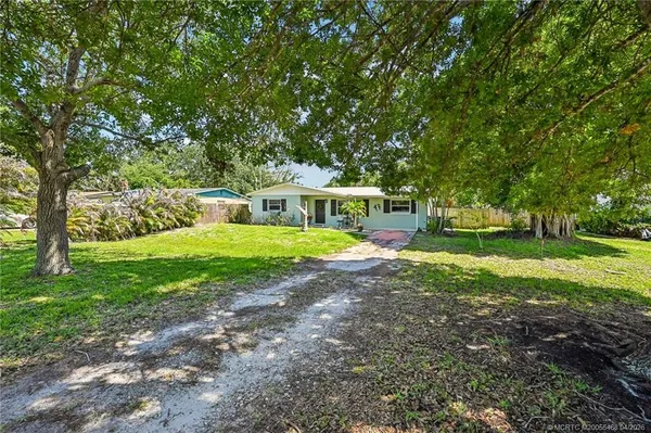 a view of house with yard and green space