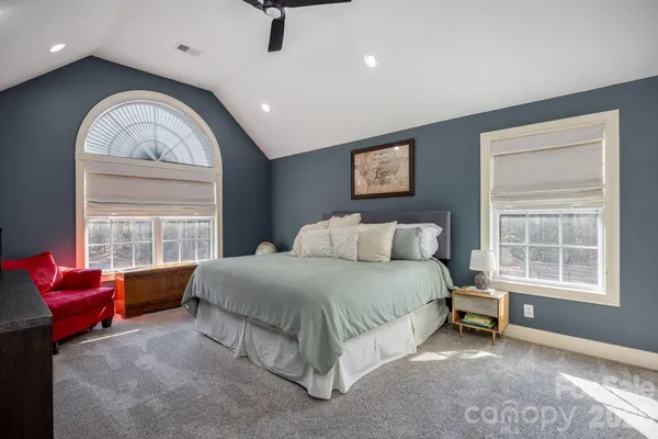 a spacious bedroom with a bed and a window