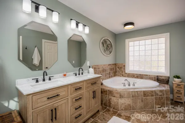 a bathroom with a double vanity sink and a bathtub