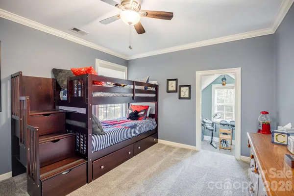 a bed room with a bed and a ceiling fan