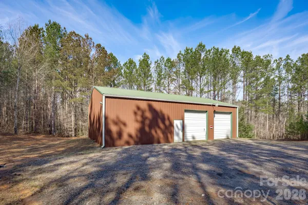 a kitchen with granite countertop a sink and refrigerator