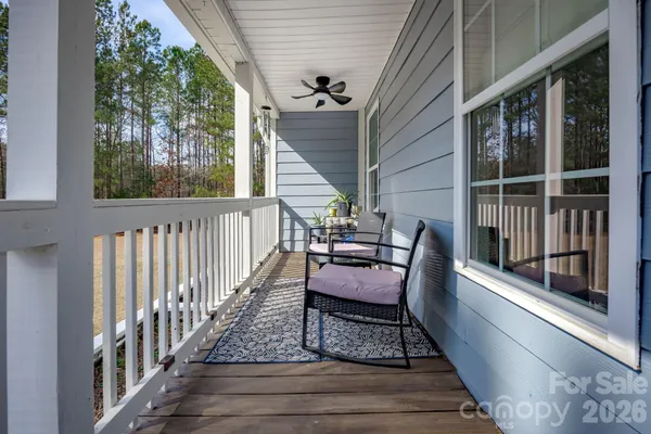 a view of two chairs in the balcony
