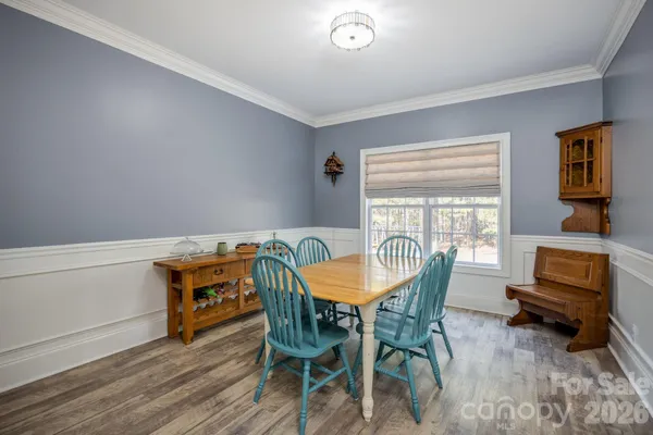 a view of a dining room with furniture and a window