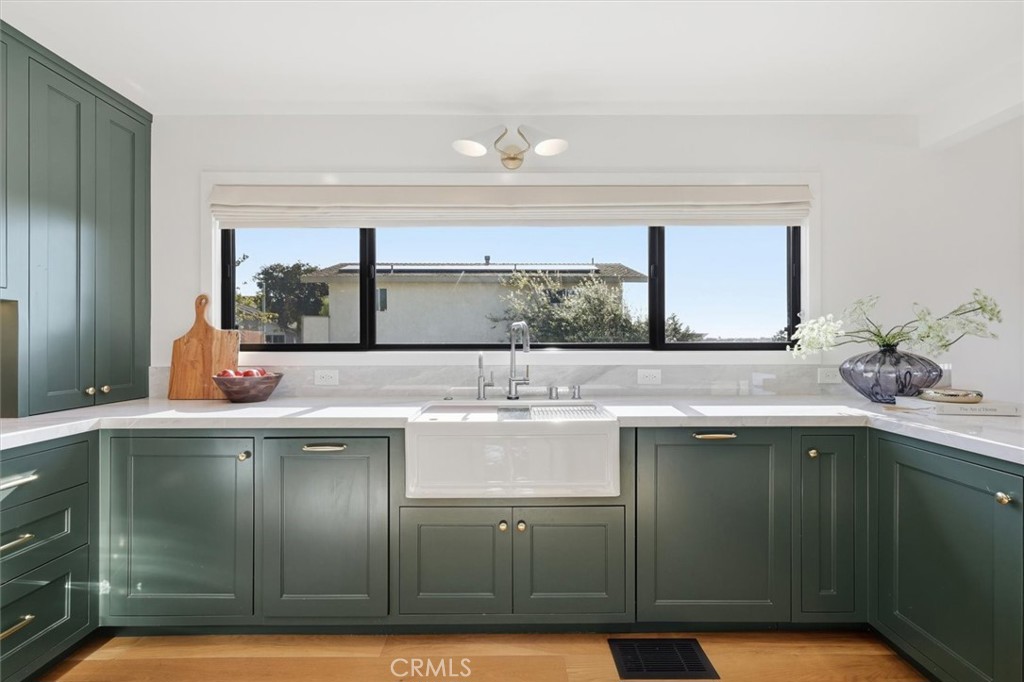 1909 Springfield Avenue Hermosa Beach, CA 90254 - Photo 11 of 31 a view of a kitchen with kitchen island a sink stainless steel appliances wooden floor and a counter top space