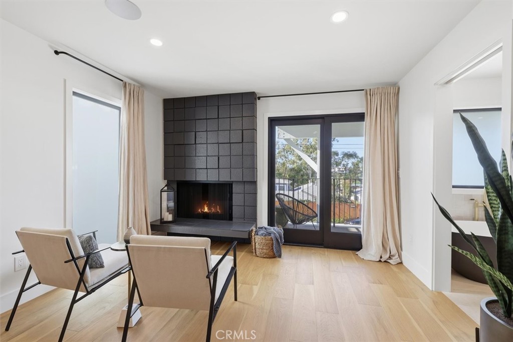 1909 Springfield Avenue Hermosa Beach, CA 90254 - Photo 21 of 31 a living room with furniture a fireplace and a flat screen tv