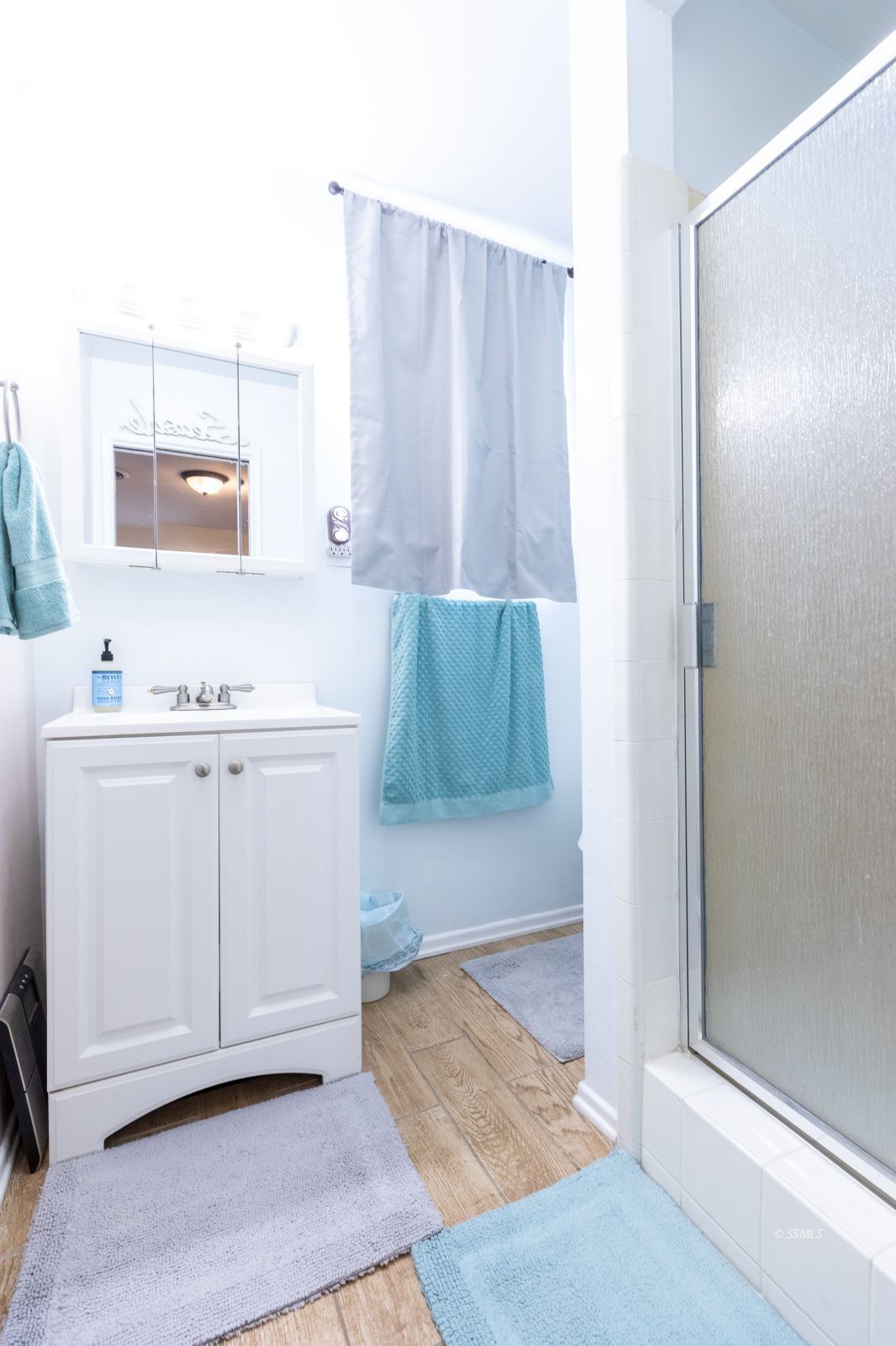 317 South Silver Ridge Street Ridgecrest, CA 93555 - Photo 17 of 28 a bathroom with a sink a mirror and a shower