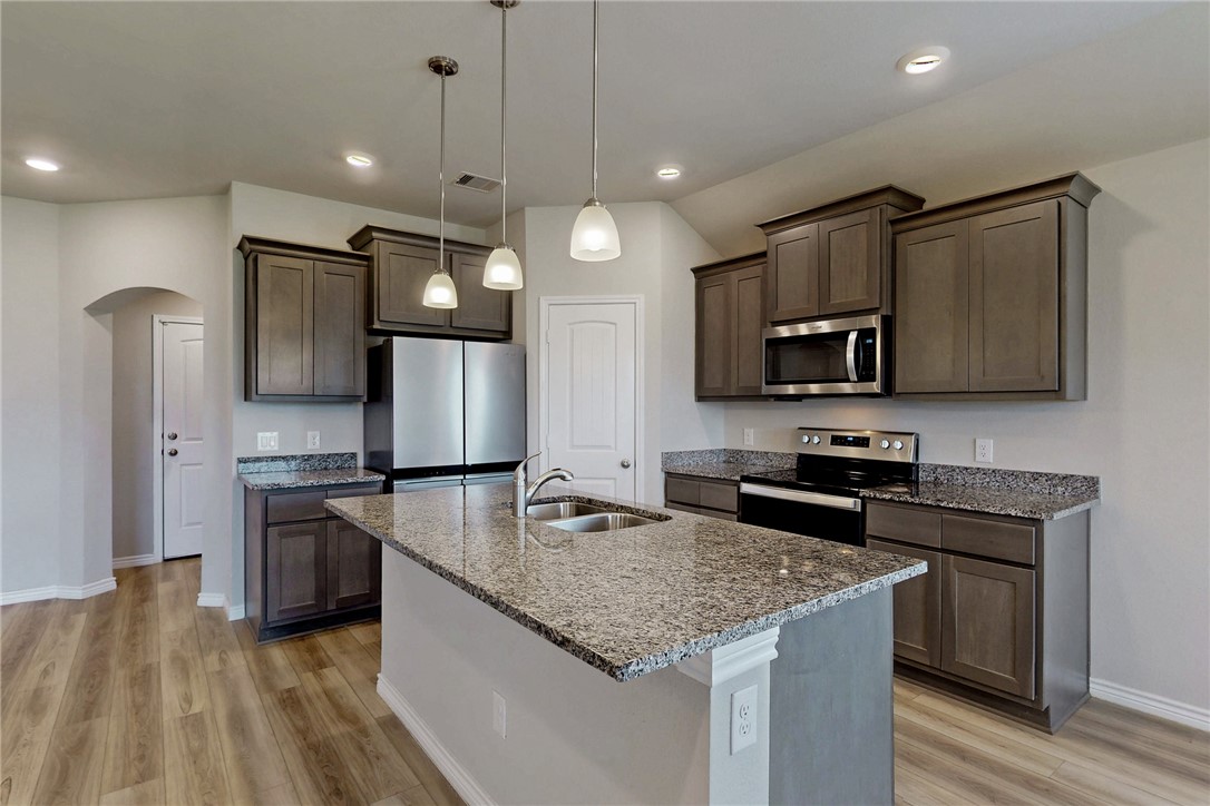 2010 Chief Street Bryan, TX 77807 - Photo 16 of 29 a kitchen with stainless steel appliances granite countertop microwave stove top oven and refrigerator