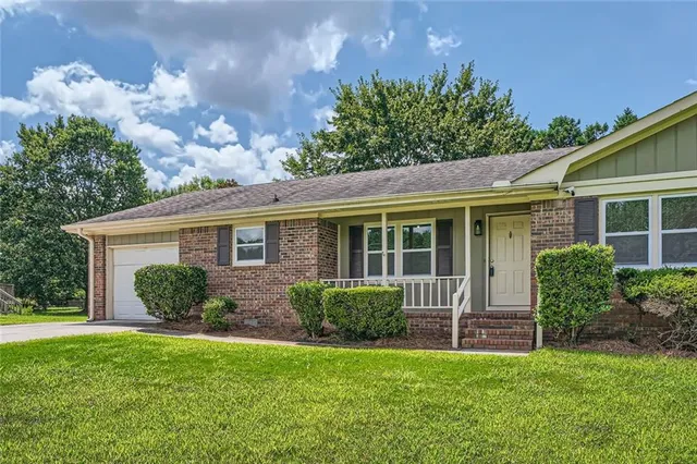 a front view of a house with garden