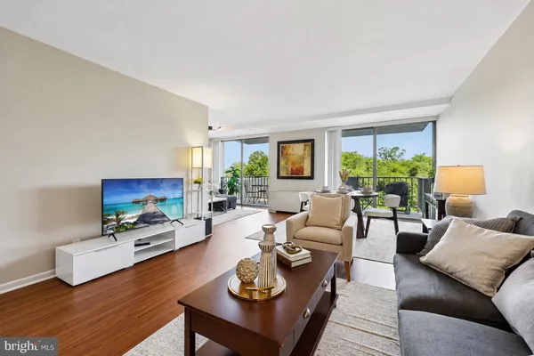 a living room with furniture fireplace and a large window