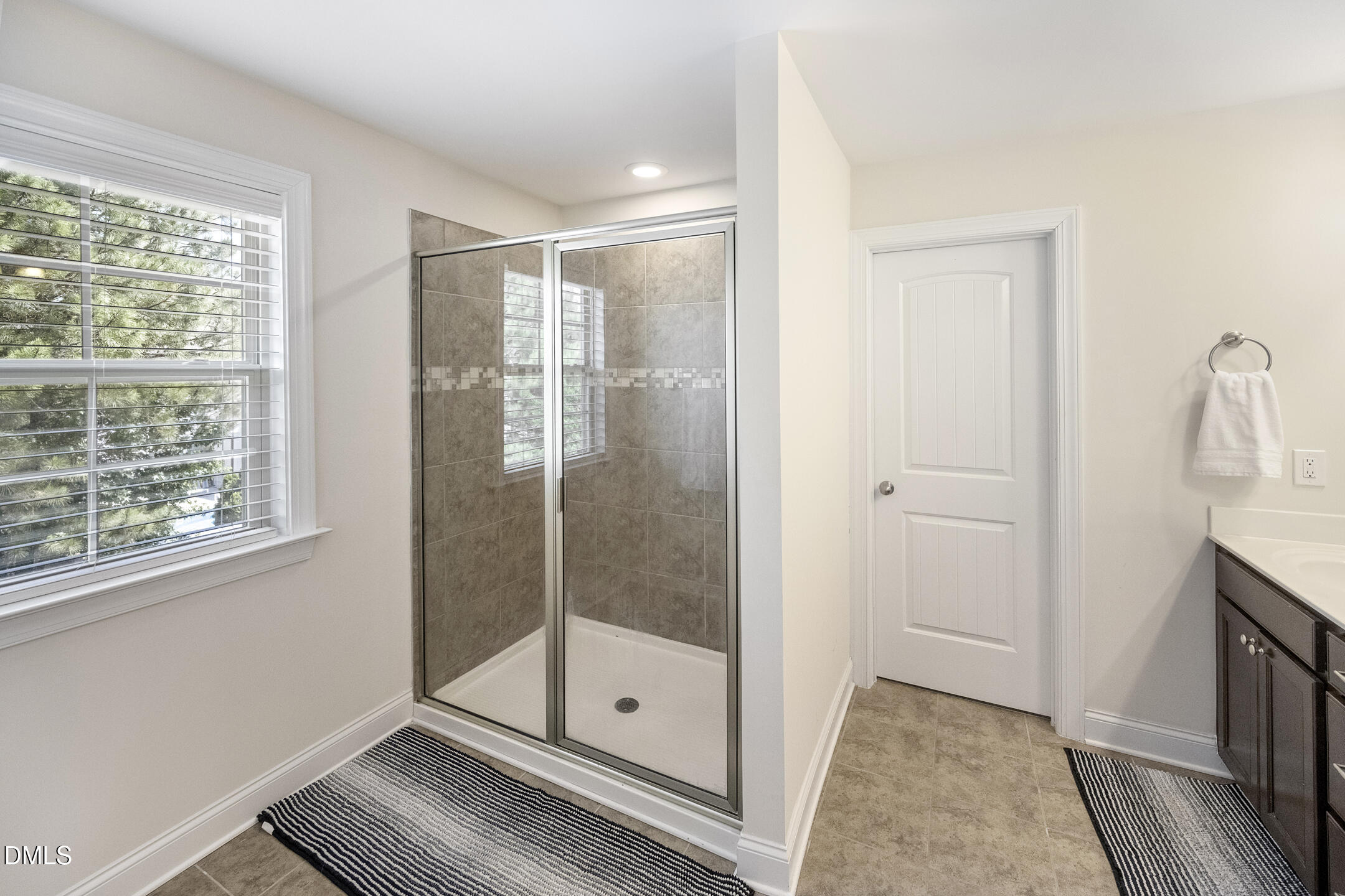 3541 Fairstone Road Wake Forest, NC 27587 - Photo 21 of 39 a bathroom with a glass shower door and a window