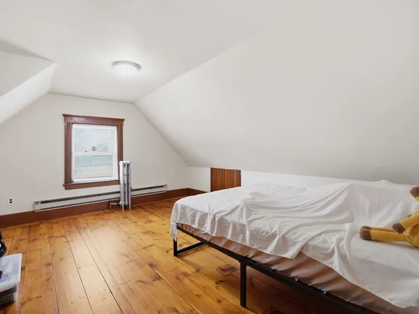 a living room with hard wood floors and a wooden floor