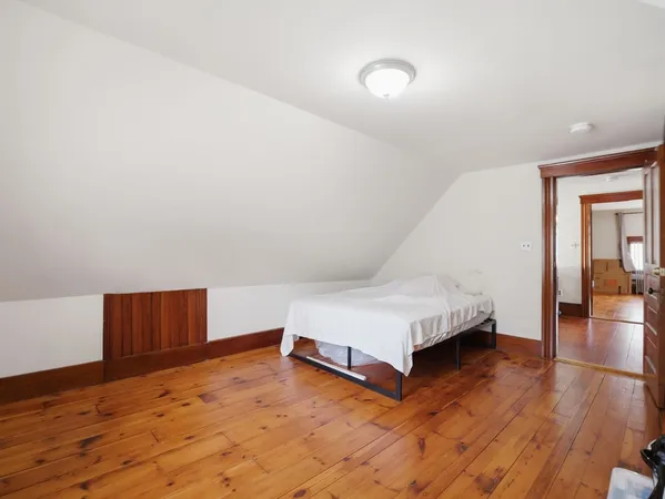 a bedroom with furniture and a wooden floor