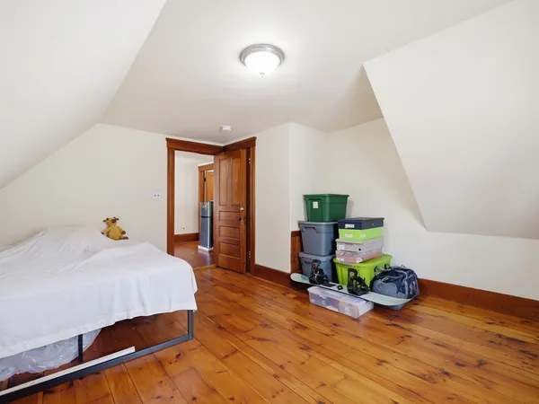 a view of a livingroom with wooden floor and furniture