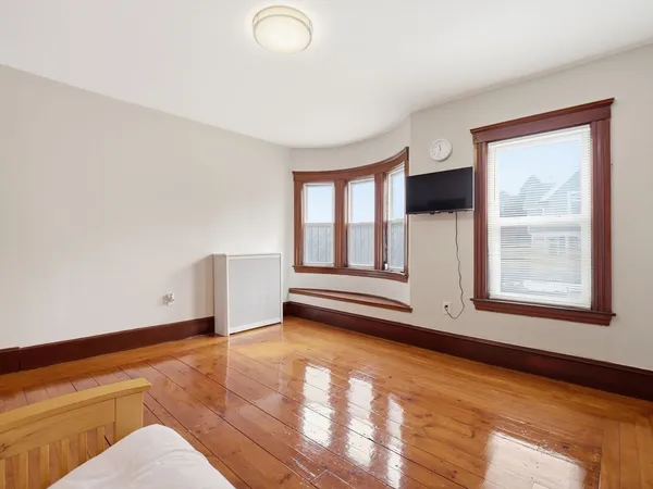a dining room with furniture and wooden floor