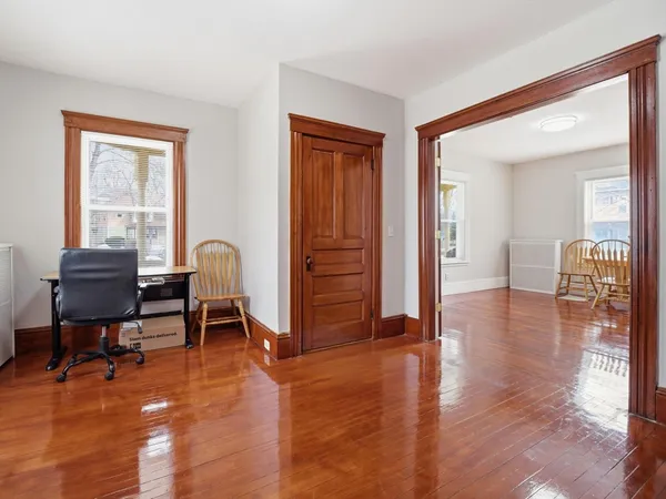 a living room with fireplace furniture and a wooden floor