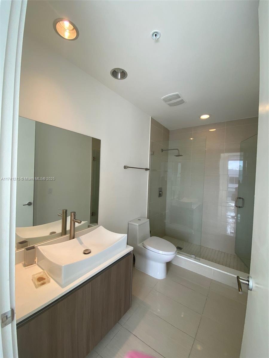 201 Southwest 17th Road, Unit 806 Miami, FL 33129 - Photo 7 of 10 a bathroom with a sink toilet and shower