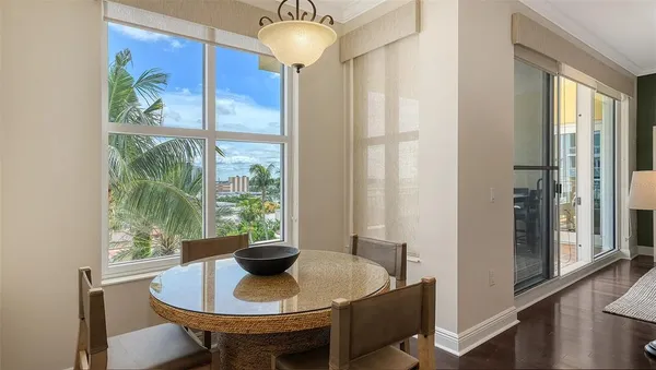 a dining room with furniture and a potted plant