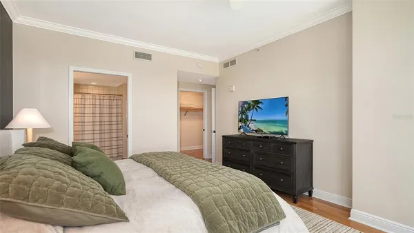 a bedroom with a bed and a television