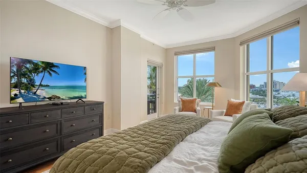 a large bedroom with a bed and large window