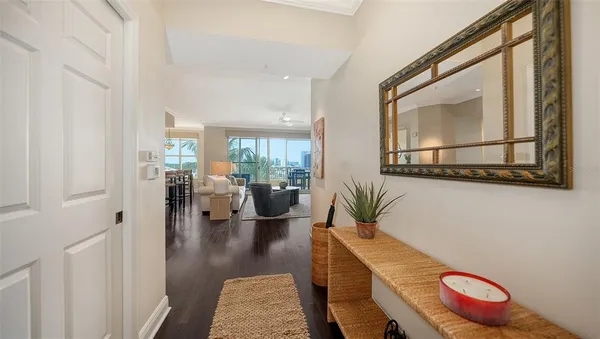 a living room with furniture a flat screen tv and a large window