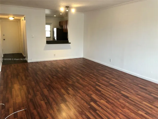 a view of a room with wooden floor and stairs
