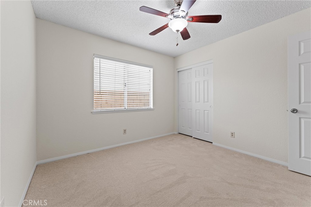 43610 16th Street East Lancaster, CA 93535 - Photo 11 of 21 an empty room with a window and a fan