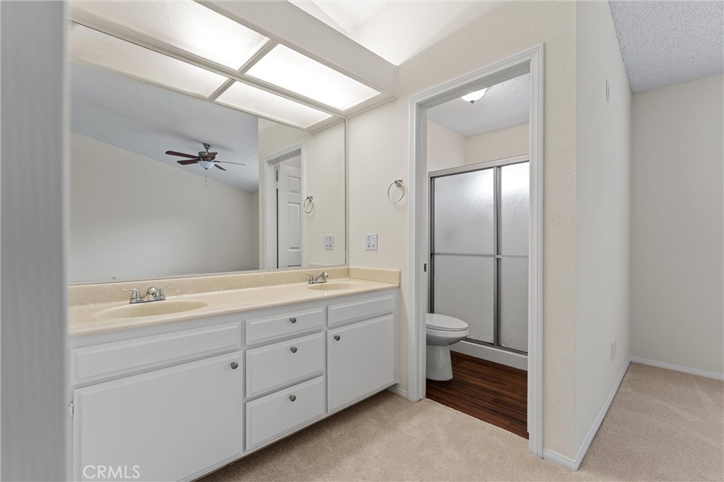 43610 16th Street East Lancaster, CA 93535 - Photo 15 of 21 a bathroom with a double vanity sink toilet mirror and double