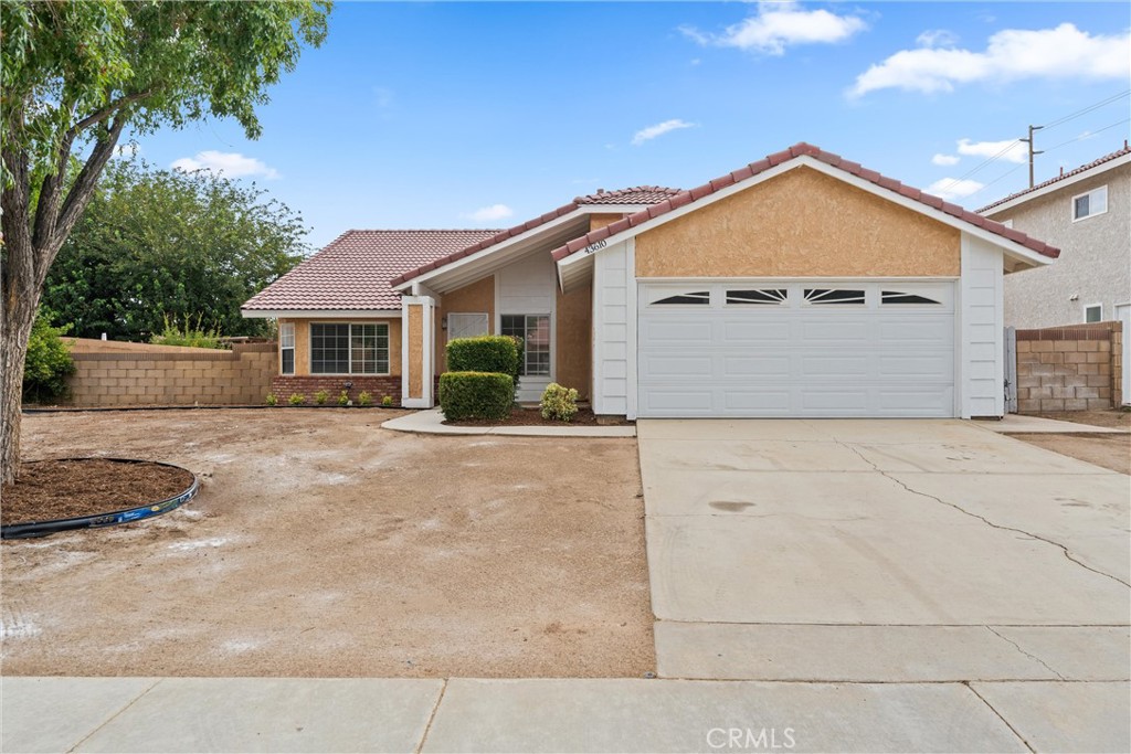 43610 16th Street East Lancaster, CA 93535 - Photo 2 of 21 a view of a house with a yard and plants