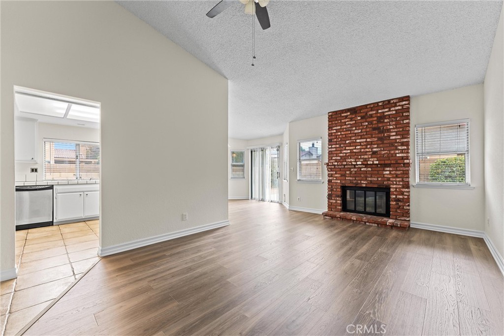43610 16th Street East Lancaster, CA 93535 - Photo 5 of 21 a view of a livingroom with wooden floor a fireplace and window