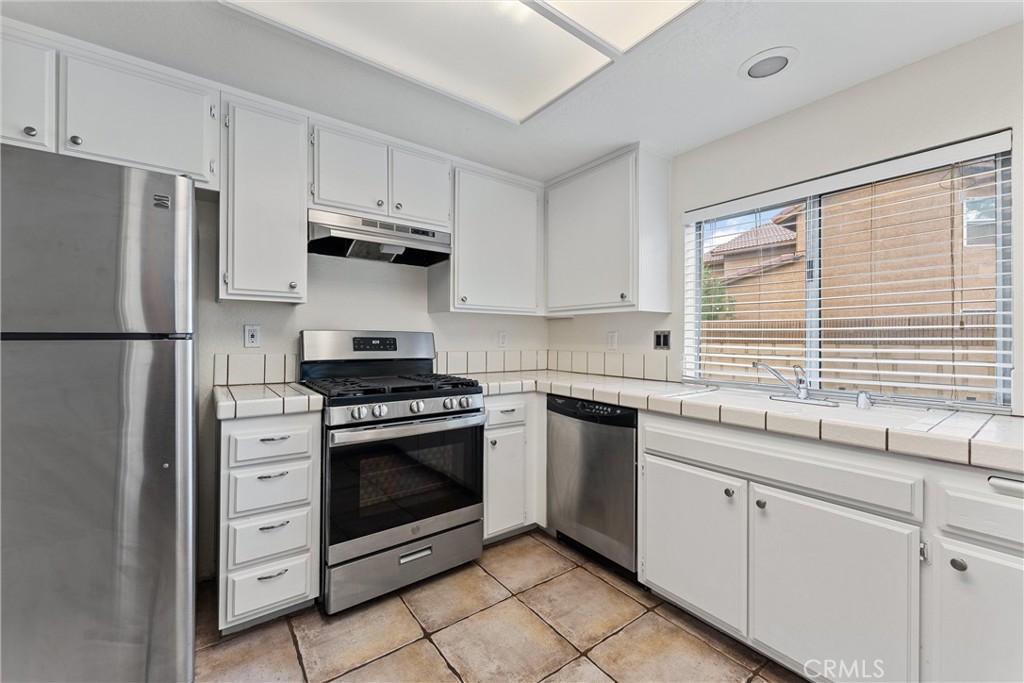 43610 16th Street East Lancaster, CA 93535 - Photo 7 of 21 a kitchen with white cabinets and appliances