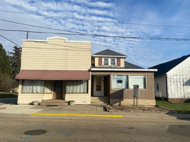 a view of a house with sitting area and a yard