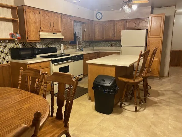 a kitchen with a sink a stove and a refrigerator