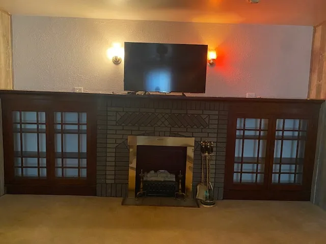 a living room with a fireplace and a flat screen tv