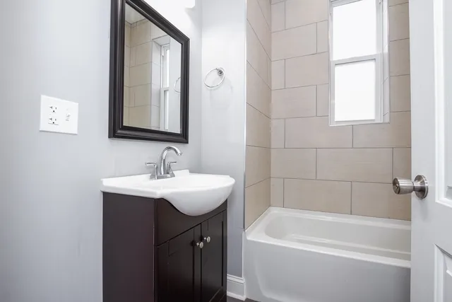 a white bath tub sitting next to a white sink