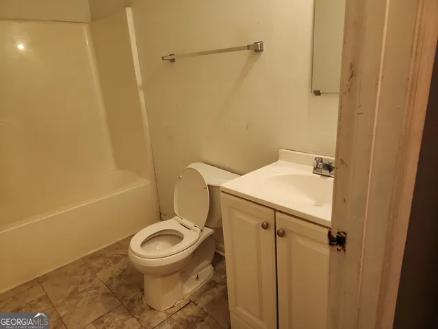 a bathroom with a toilet and a sink