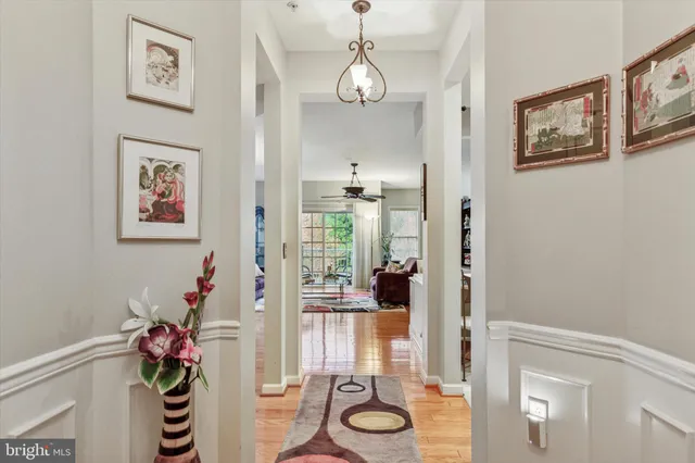 a view of a hallway with wooden floor and windows