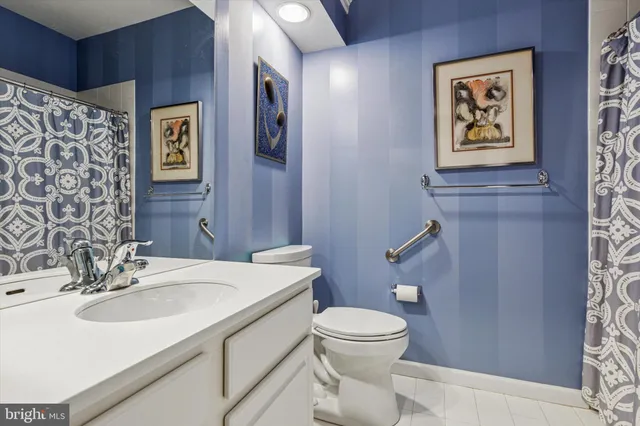 a bathroom with a sink mirror vanity and toilet