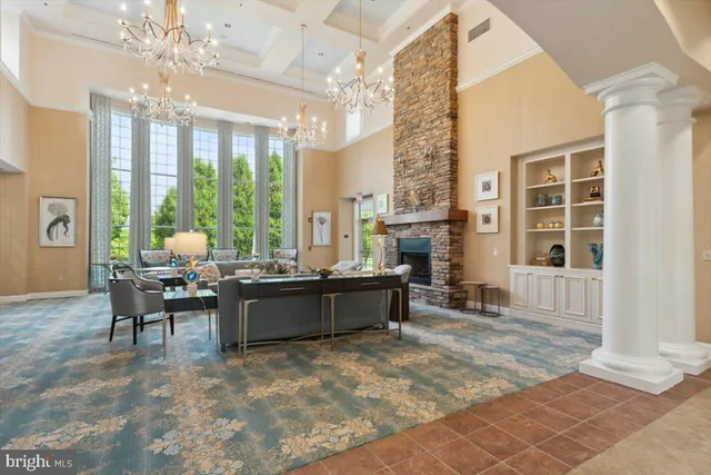 a living room with furniture large window and floor to ceiling windows