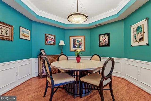 a view of a dining room with furniture and a chandelier