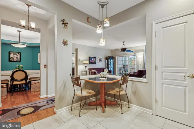 a view of a dining room with furniture and chandelier
