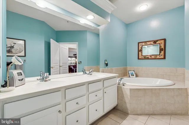 a bathroom with a double vanity sink a mirror and a