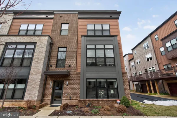 a front view of a residential apartment building with a yard