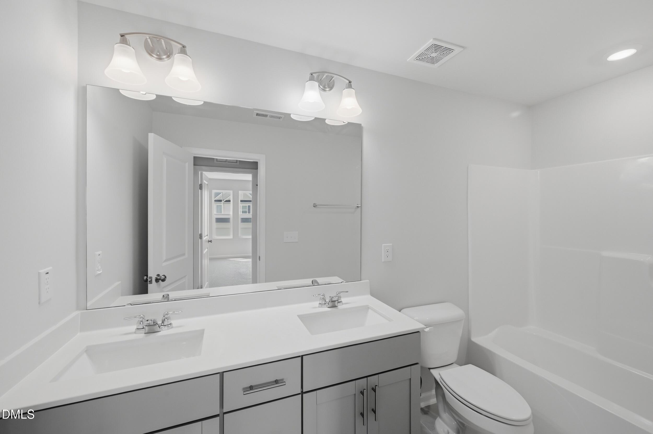 5011 Kota Street Raleigh, NC 27610 - Photo 25 of 42 a bathroom with a sink toilet tub and shower