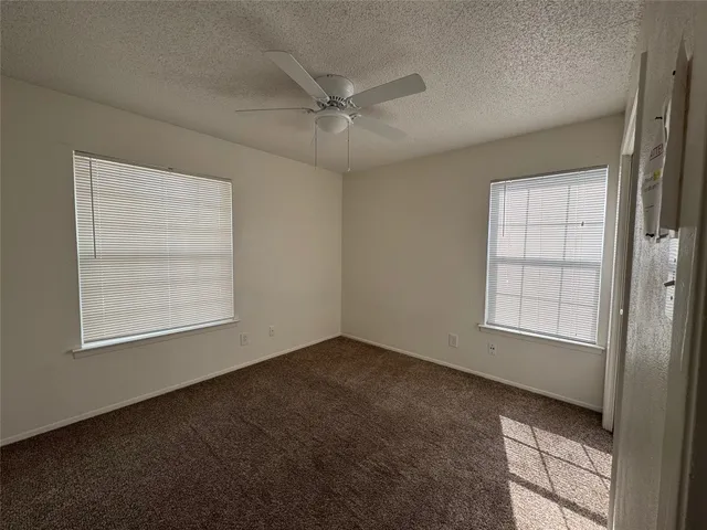 an empty room with windows and closet
