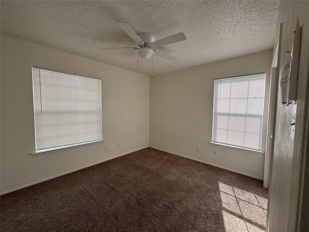 4810 West Wind Trail, Unit 104 Austin, TX 78745 - Photo 12 of 21 an empty room with windows and closet