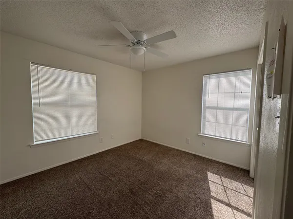 an empty room with windows and closet