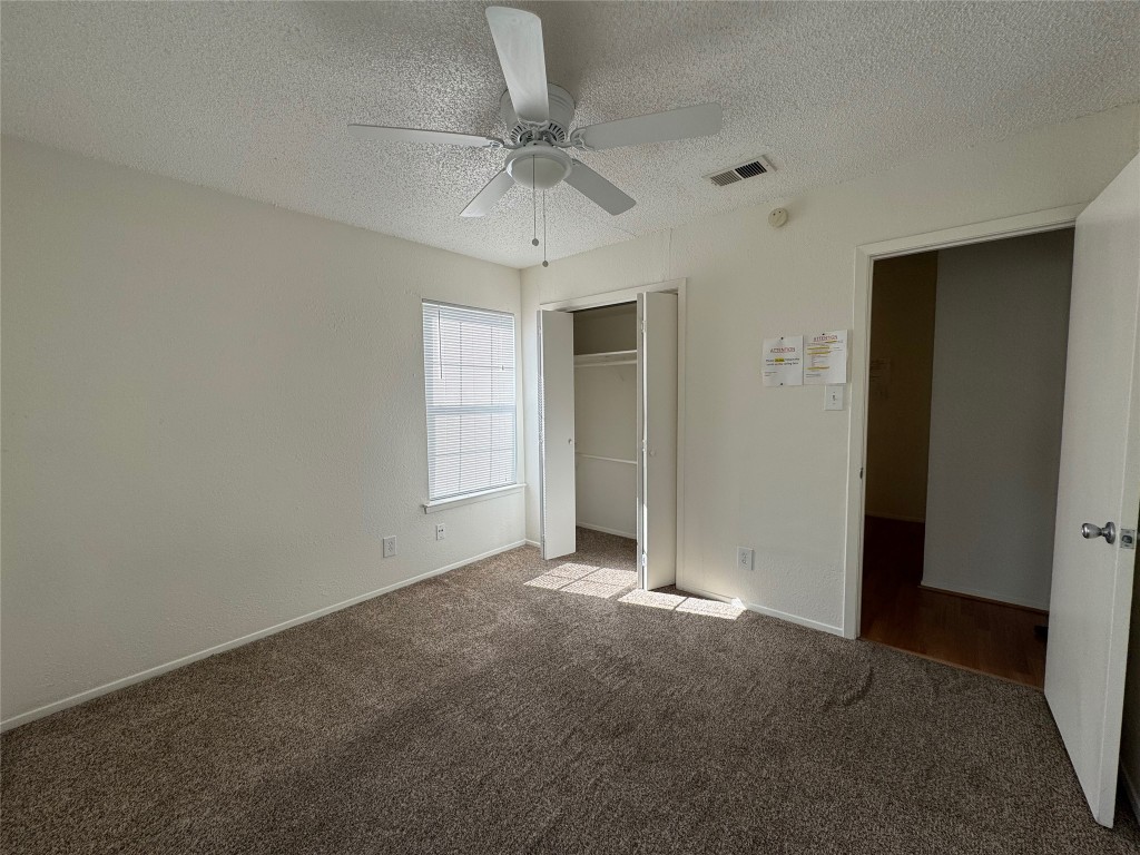 4810 West Wind Trail, Unit 104 Austin, TX 78745 - Photo 13 of 21 an empty room with a ceiling fan and a window