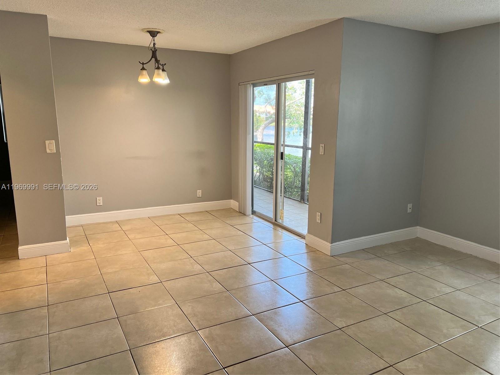1261 Southwest 46th Avenue, Unit 2003 Pompano Beach, FL 33069 - Photo 2 of 9 a view of an empty room with a window